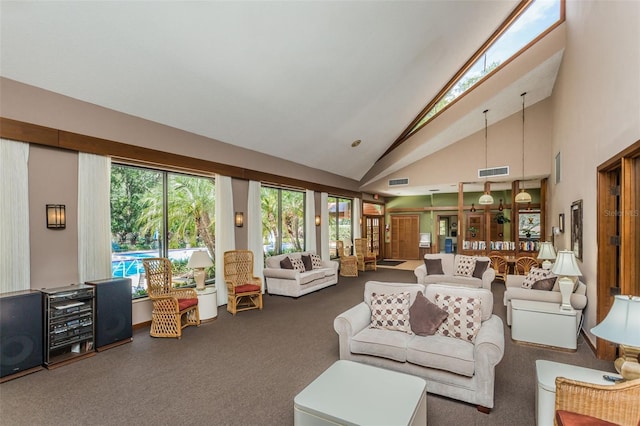 living room featuring carpet flooring, healthy amount of natural light, and high vaulted ceiling