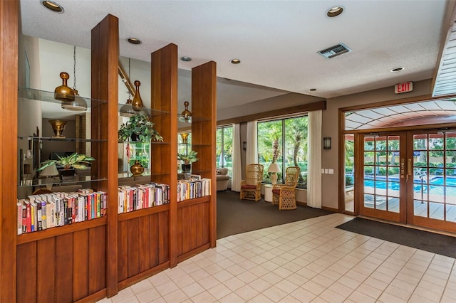 reception featuring french doors and recessed lighting