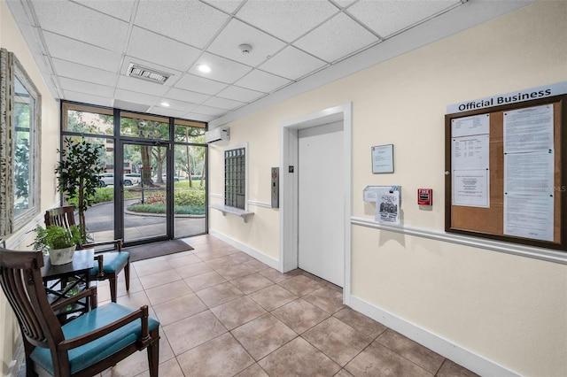 welcome area featuring a drop ceiling, floor to ceiling windows, and recessed lighting