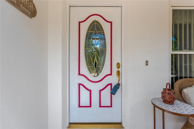 property entrance with stucco siding