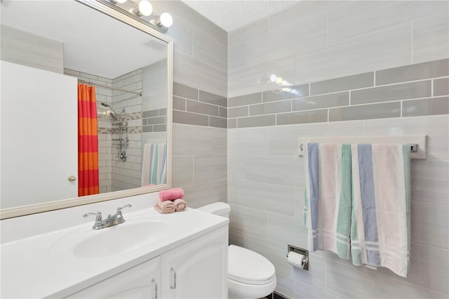 bathroom with vanity, toilet, a textured ceiling, and a shower with shower curtain
