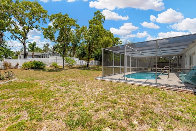view of yard with a fenced backyard, a fenced in pool, a patio area, and glass enclosure