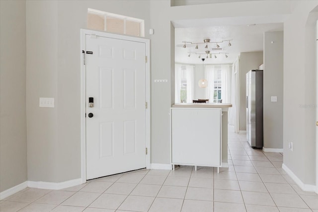 6260 Olivedale Dr, Riverview, FL 33578 - foyer entrance featuring light tile patterned floors, rail lighting, and baseboards