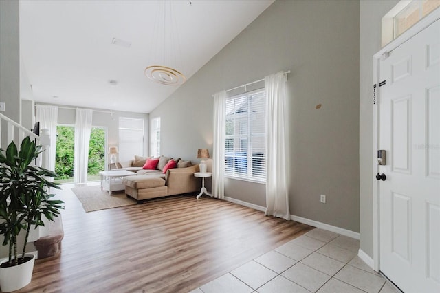 6260 Olivedale Dr, Riverview, FL 33578 - living room featuring light wood finished floors, baseboards, and high vaulted ceiling
