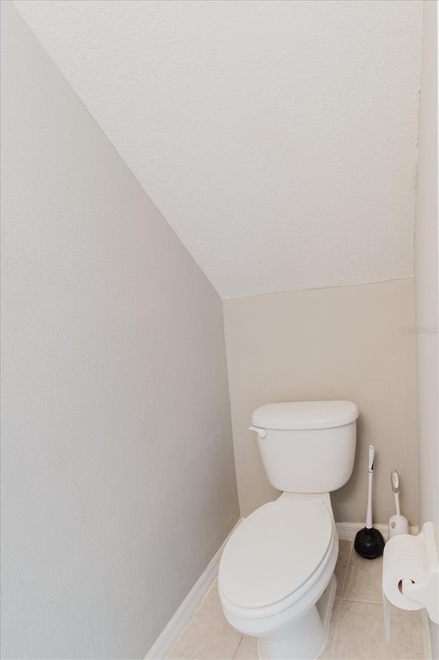 6260 Olivedale Dr, Riverview, FL 33578 - bathroom with lofted ceiling, tile patterned floors, toilet, and baseboards