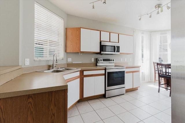 6260 Olivedale Dr, Riverview, FL 33578 - kitchen featuring stainless steel microwave, electric range, rail lighting, a sink, and white cabinets