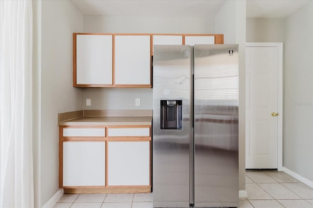 6260 Olivedale Dr, Riverview, FL 33578 - kitchen with stainless steel refrigerator with ice dispenser, light tile patterned floors, light countertops, and baseboards