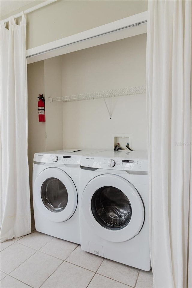 6260 Olivedale Dr, Riverview, FL 33578 - laundry room featuring washing machine and dryer and light tile patterned flooring