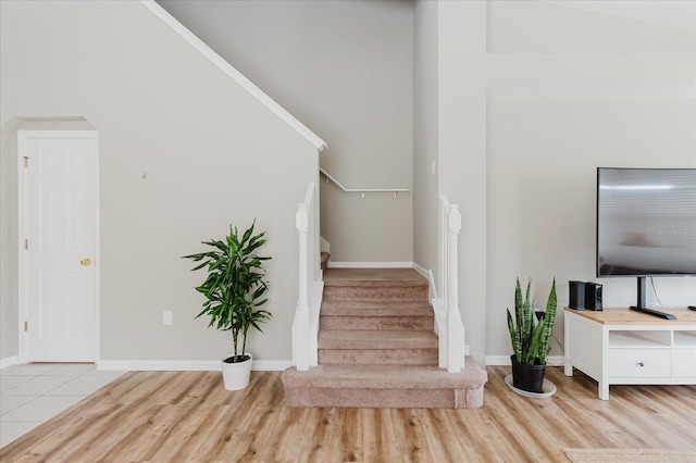 6260 Olivedale Dr, Riverview, FL 33578 - stairway with wood finished floors, baseboards, and a towering ceiling