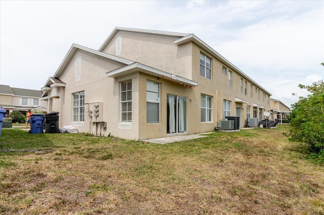 6260 Olivedale Dr, Riverview, FL 33578 - rear view of house with cooling unit, a yard, and stucco siding