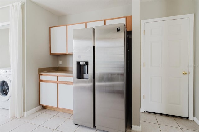 6260 Olivedale Dr, Riverview, FL 33578 - kitchen featuring stainless steel fridge, washer / dryer, light tile patterned flooring, white cabinets, and baseboards