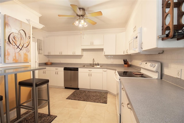 kitchen with a sink, ceiling fan, white cabinets, and white appliances