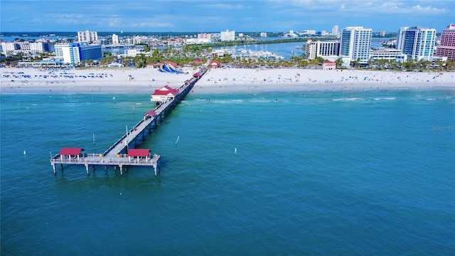 drone / aerial view with a water view, a city view, and a view of the beach