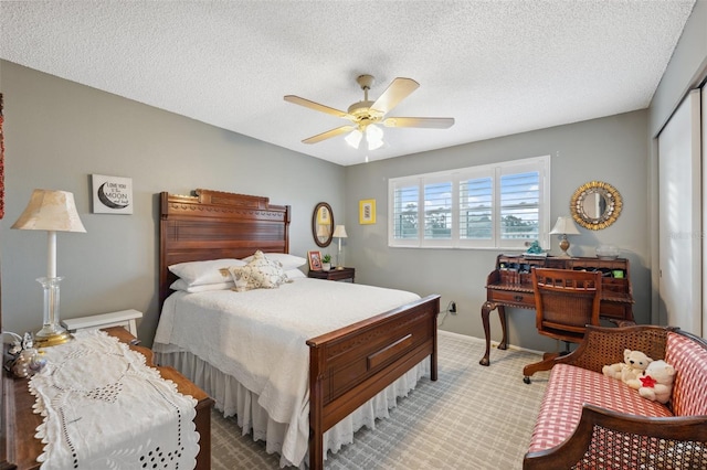bedroom featuring ceiling fan, a textured ceiling, carpet floors, baseboards, and a closet
