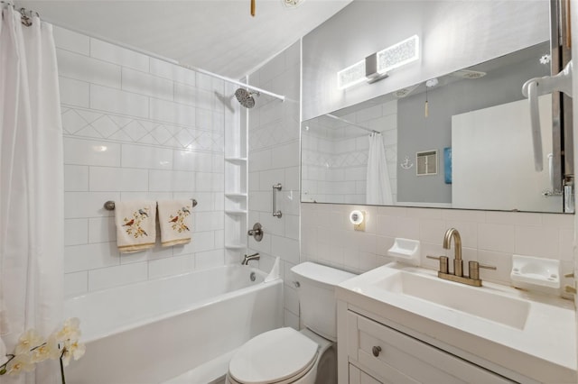 bathroom with vanity, shower / bath combo with shower curtain, toilet, tile walls, and backsplash