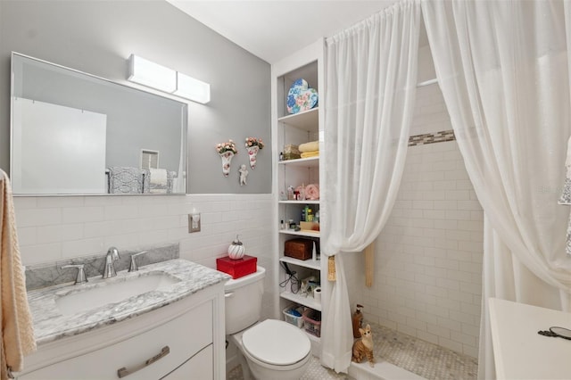 full bath featuring vanity, toilet, tile walls, and a stall shower