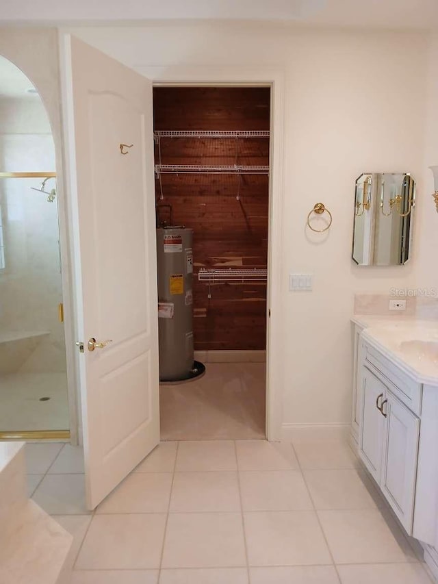 bathroom featuring a stall shower, tile patterned floors, and water heater