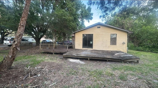 rear view of house featuring a wooden deck