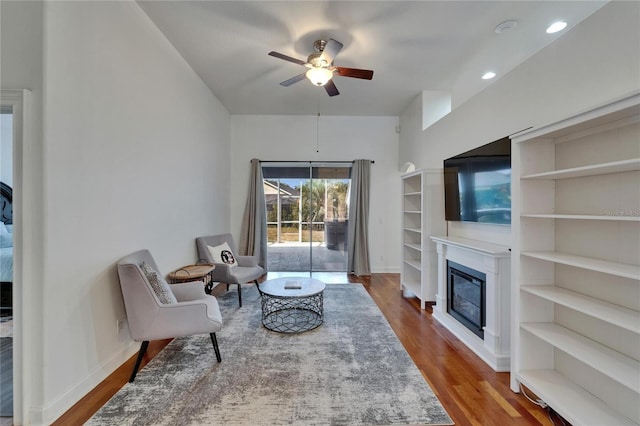 16516 Bridgewalk Dr, Lithia, FL 33547 - living room with baseboards, a glass covered fireplace, ceiling fan, and wood finished floors