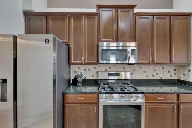 16516 Bridgewalk Dr, Lithia, FL 33547 - kitchen with appliances with stainless steel finishes, decorative backsplash, and dark stone countertops