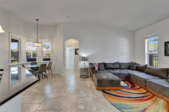 16516 Bridgewalk Dr, Lithia, FL 33547 - living room featuring a chandelier, light tile patterned flooring, and arched walkways