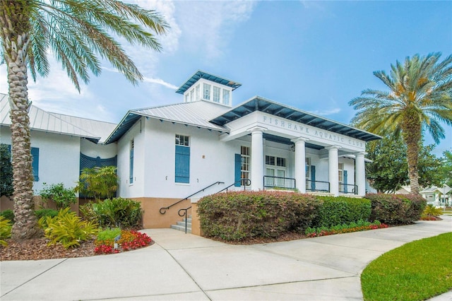 16516 Bridgewalk Dr, Lithia, FL 33547 - view of front of home with a standing seam roof, metal roof, stucco siding, and covered porch