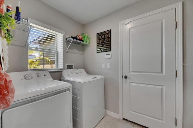 11707 Sunburst Marble Rd, Riverview, FL 33579 - washroom with washer and clothes dryer, light tile patterned floors, and baseboards