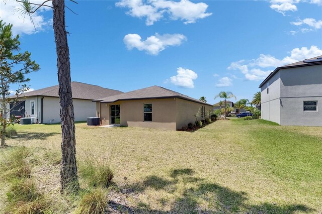 11707 Sunburst Marble Rd, Riverview, FL 33579 - back of property featuring a yard, stucco siding, and central air condition unit