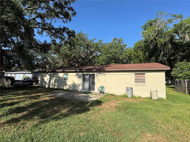 1703 N Taylor Rd, Brandon, FL 33510 - back of house featuring a yard, fence, and concrete block siding