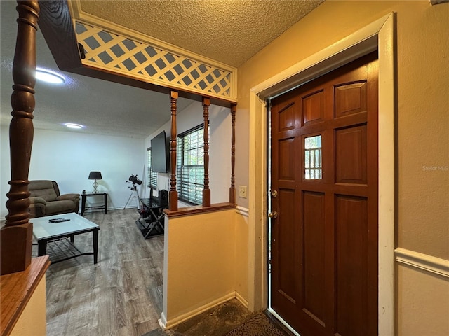 1703 N Taylor Rd, Brandon, FL 33510 - foyer featuring baseboards, a textured ceiling, and wood finished floors