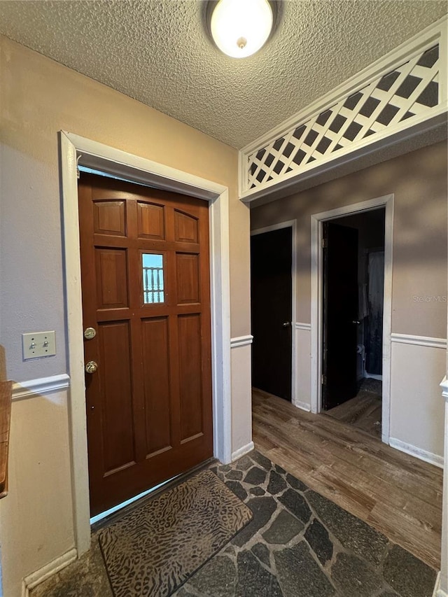 1703 N Taylor Rd, Brandon, FL 33510 - foyer featuring a textured ceiling and wood finished floors