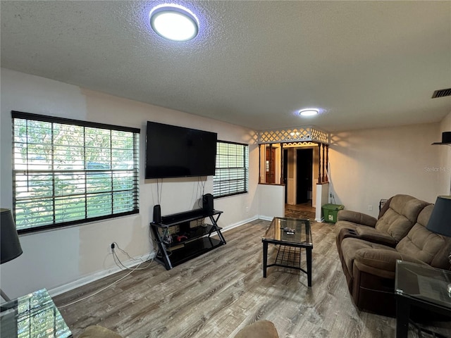 1703 N Taylor Rd, Brandon, FL 33510 - living room featuring baseboards, a textured ceiling, wood finished floors, and visible vents