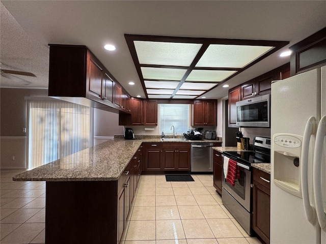 1703 N Taylor Rd, Brandon, FL 33510 - kitchen with a sink, appliances with stainless steel finishes, stone counters, and light tile patterned flooring