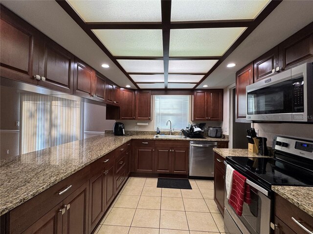 1703 N Taylor Rd, Brandon, FL 33510 - kitchen with appliances with stainless steel finishes, a sink, recessed lighting, stone counters, and light tile patterned floors