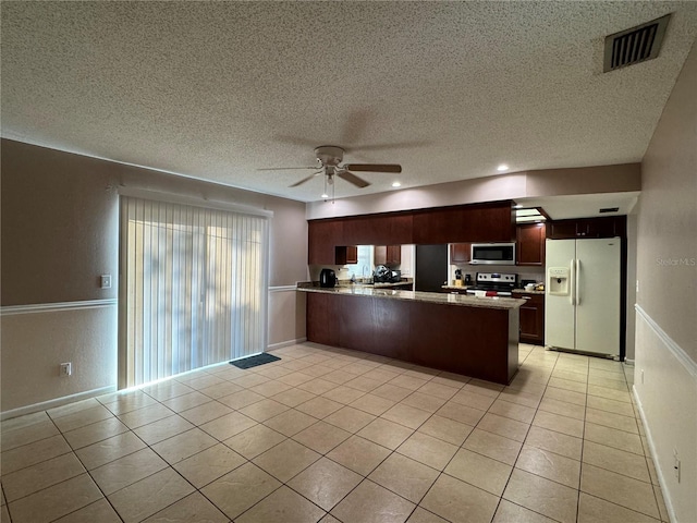 1703 N Taylor Rd, Brandon, FL 33510 - kitchen with appliances with stainless steel finishes, a peninsula, a textured ceiling, and visible vents