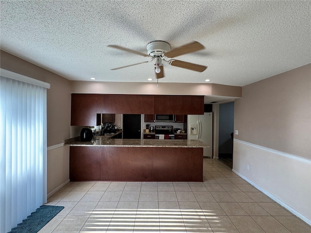 1703 N Taylor Rd, Brandon, FL 33510 - kitchen featuring a ceiling fan, a textured ceiling, appliances with stainless steel finishes, a peninsula, and light tile patterned flooring