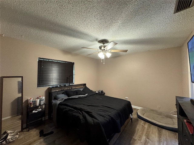 1703 N Taylor Rd, Brandon, FL 33510 - bedroom with visible vents, wood finished floors, baseboards, a textured ceiling, and a ceiling fan
