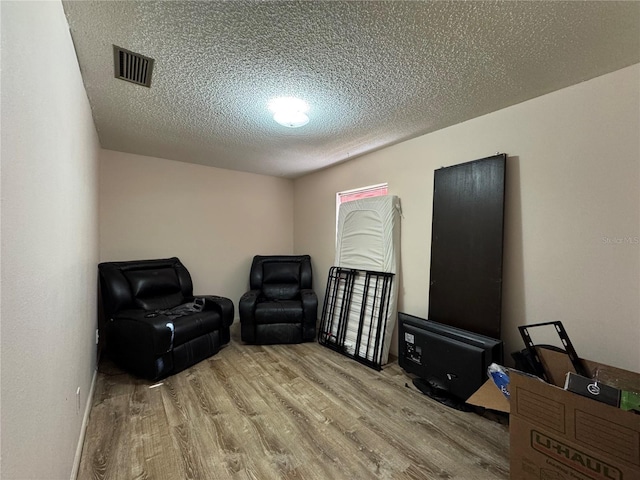 1703 N Taylor Rd, Brandon, FL 33510 - sitting room with a textured ceiling, visible vents, and wood finished floors