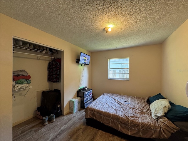 1703 N Taylor Rd, Brandon, FL 33510 - bedroom with a textured ceiling, a closet, and wood finished floors