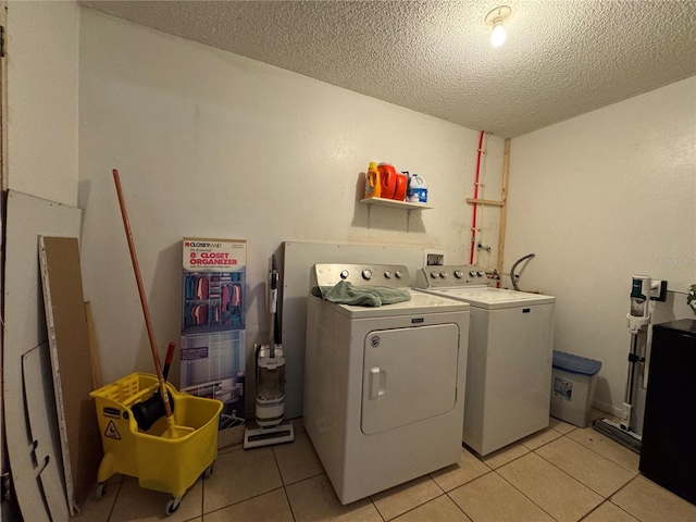 1703 N Taylor Rd, Brandon, FL 33510 - washroom featuring independent washer and dryer, light tile patterned flooring, laundry area, and a textured ceiling