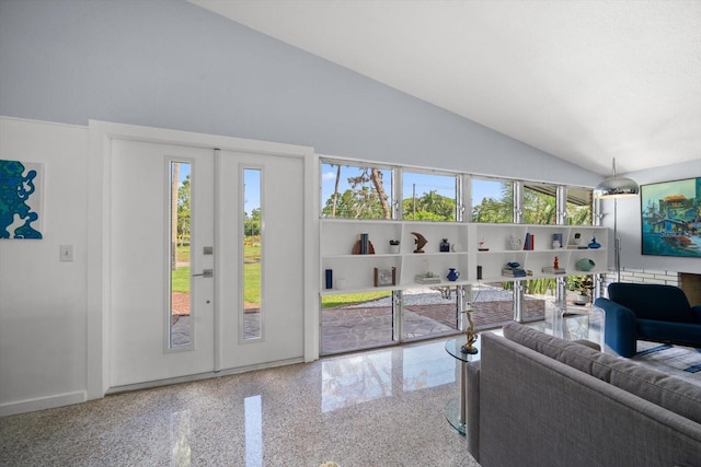living room featuring baseboards, speckled floor, and high vaulted ceiling
