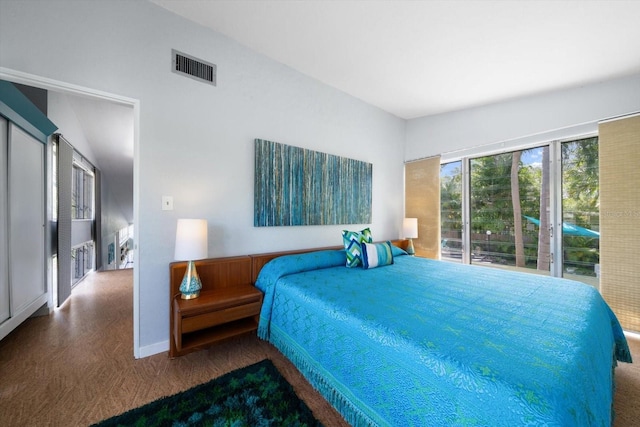 carpeted bedroom with visible vents and baseboards
