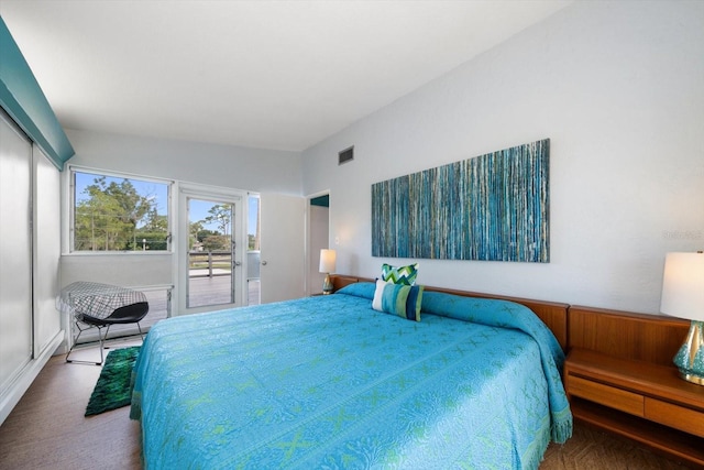 bedroom featuring visible vents, carpet floors, and access to exterior