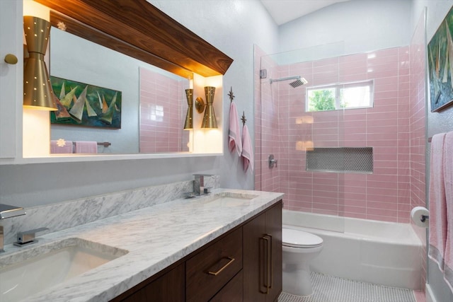 full bath with a sink, tile patterned floors, toilet, and double vanity