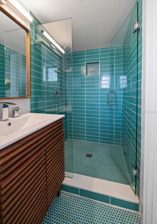 full bath with vanity and a shower stall
