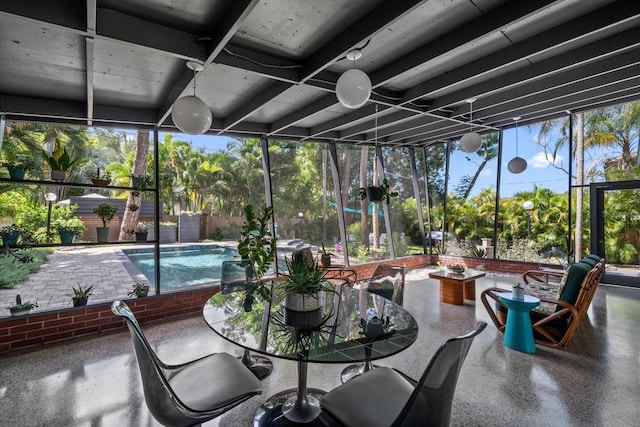 sunroom / solarium featuring speckled floor