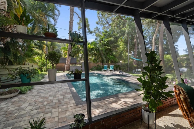 view of swimming pool with an outbuilding, a fenced in pool, a fenced backyard, a storage unit, and a patio