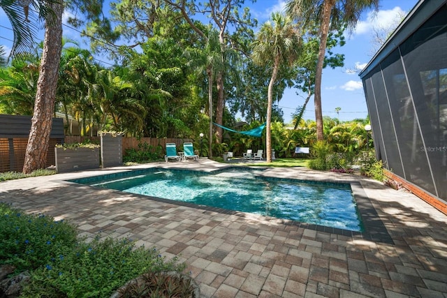 view of pool featuring fence, a fenced in pool, and a patio area