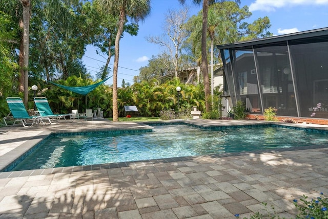 pool with a patio and a sunroom