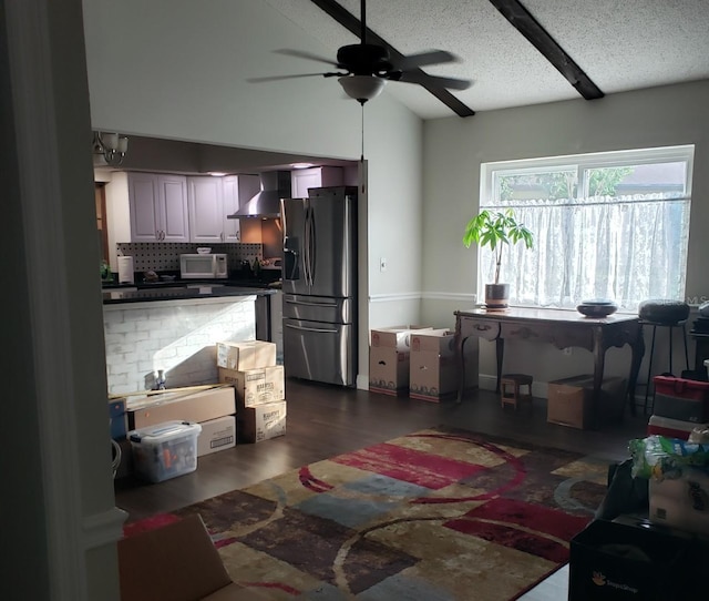living area with a textured ceiling, dark wood-type flooring, lofted ceiling, and ceiling fan